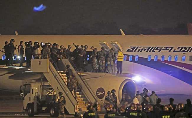 A photo of Bangladeshi security personnel standing guard near the Dubai-bound Bangladesh Biman aircraft on the tarmac Shah Amanat International Airport after the attempted hijacking on 24 February 2019