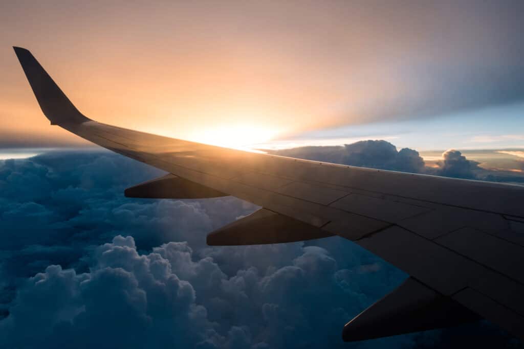 Stock imagery of a plane wing over clouds